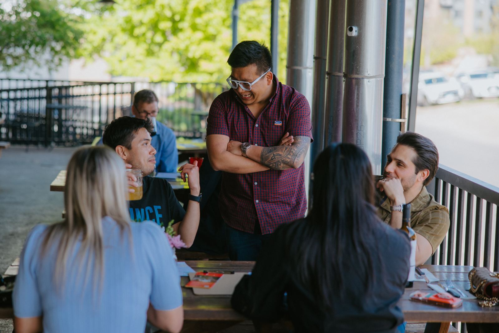 Vince laughing with neighbors around a picnic table on a patio