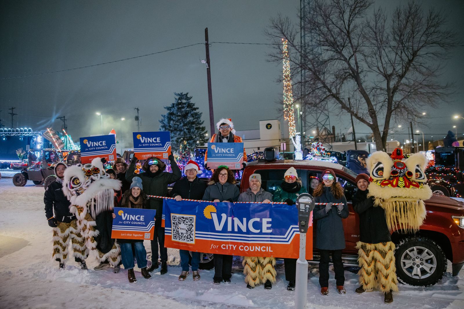Vince and friends with lion dancers at a snowy holiday parade