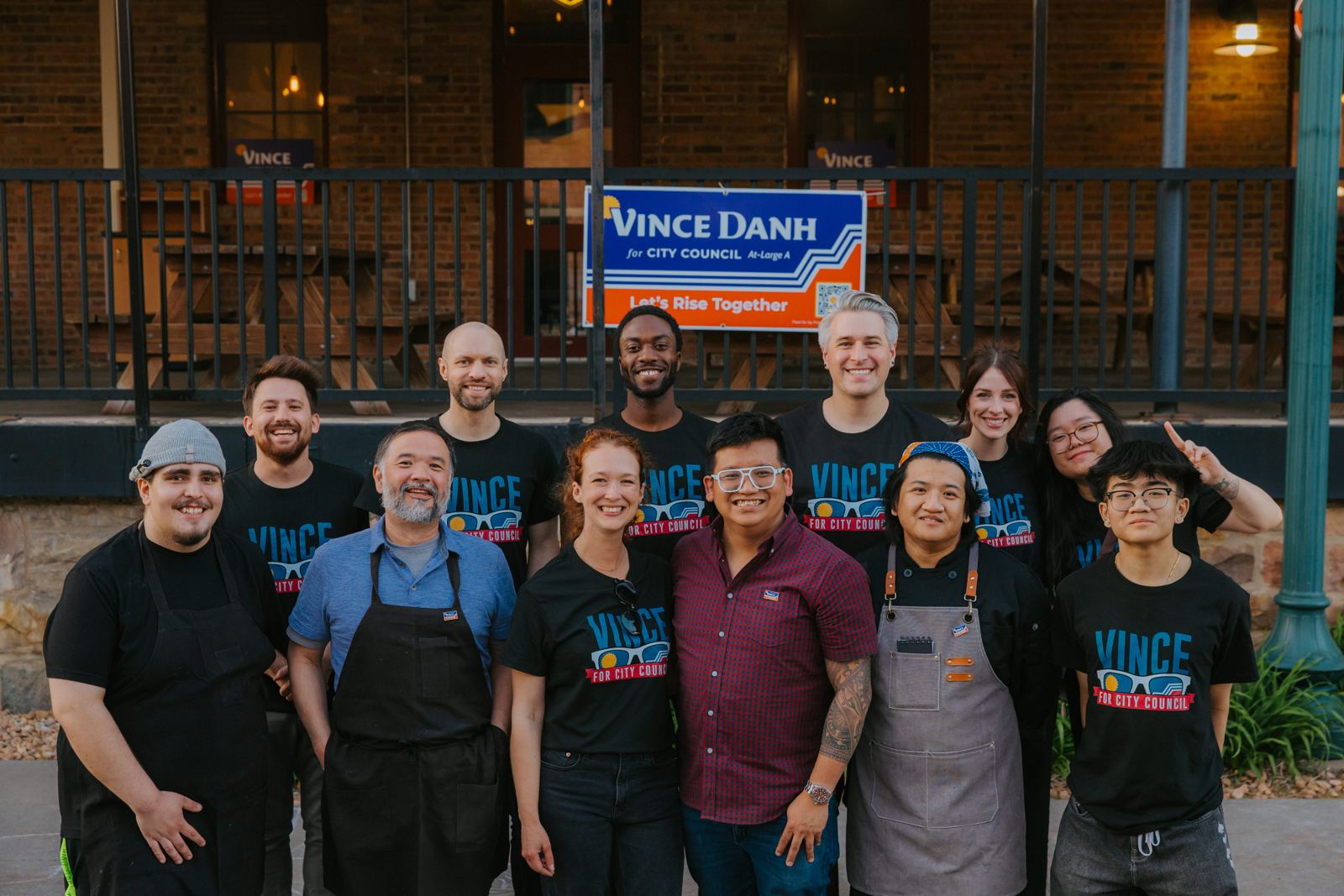 Vince with a crew of supporters and restaurant staff in campaign shirts outside a downtown restaurant
