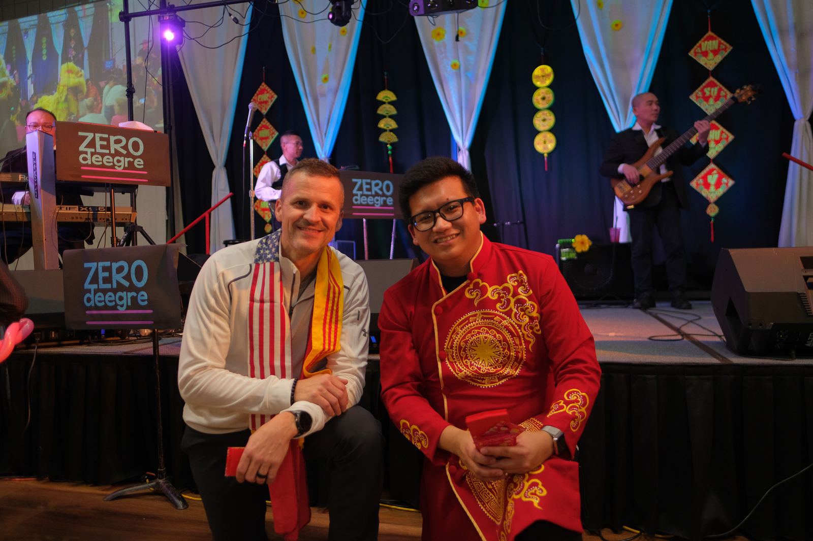 Vince in a red and gold ao dai at a Lunar New Year celebration