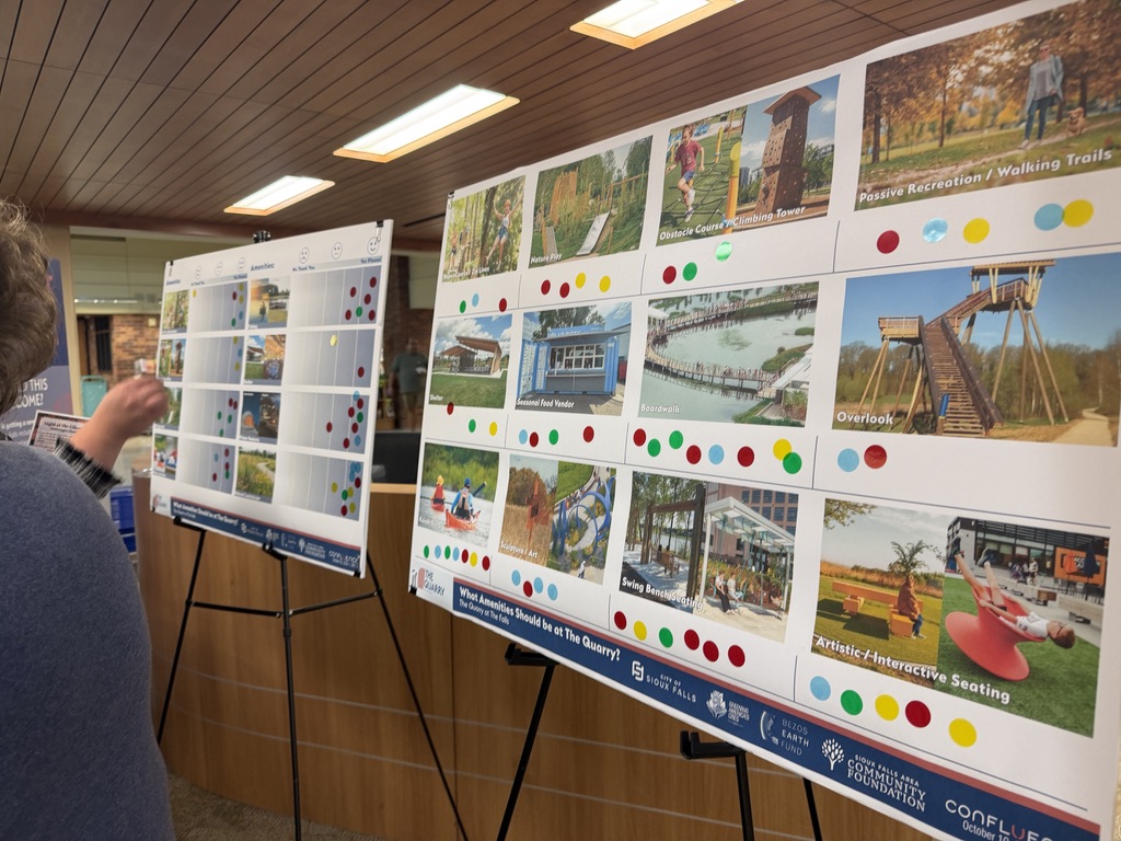 A neighbor places dots on a board asking what amenities should be at The Quarry