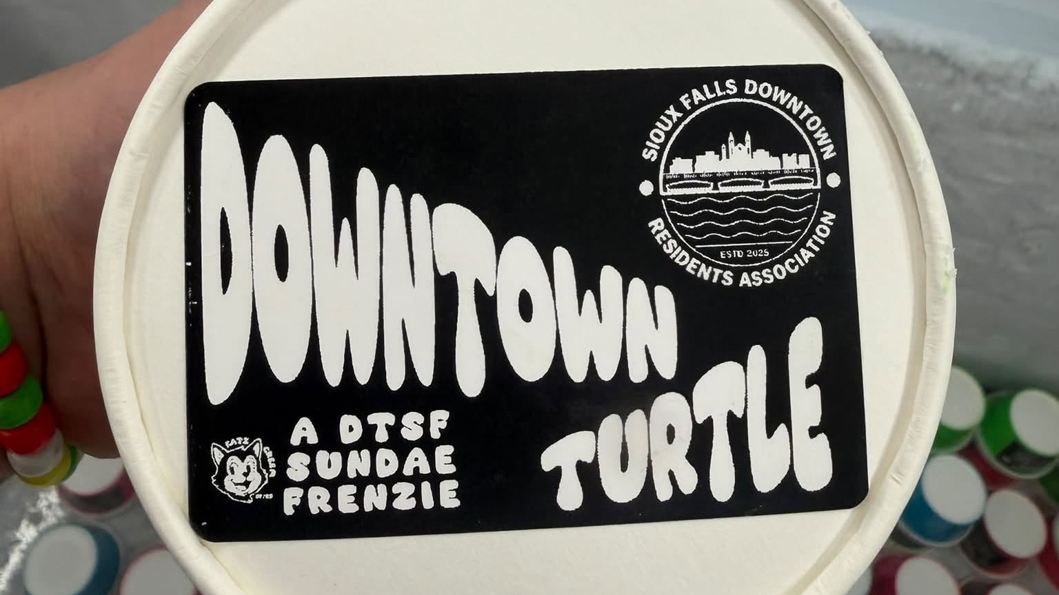A pint of Downtown Turtle ice cream from Katz Creem, with the Sioux Falls Downtown Residents Association logo on the lid