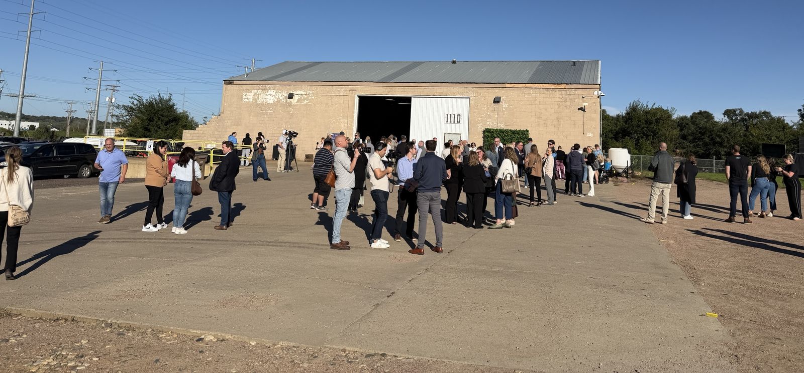 A crowd gathers outside the old warehouse at 1110 N. Weber Ave.