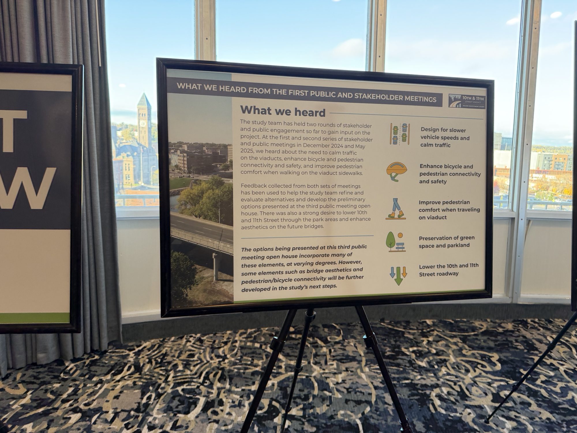Board titled What We Heard from the First Public and Stakeholder Meetings, listing slower speeds, bike and pedestrian safety, pedestrian comfort, green space and lower roadways